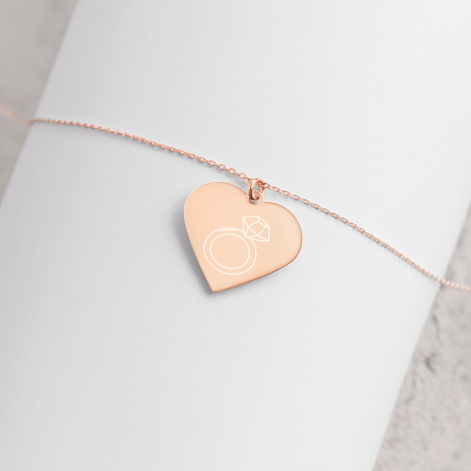 This engraved chain necklace with a sterling silver heart-shaped pendant makes for a perfect accessory for anyone in love with minimalistic and sophisticated jewelryEngraved Silver Heart Necklace