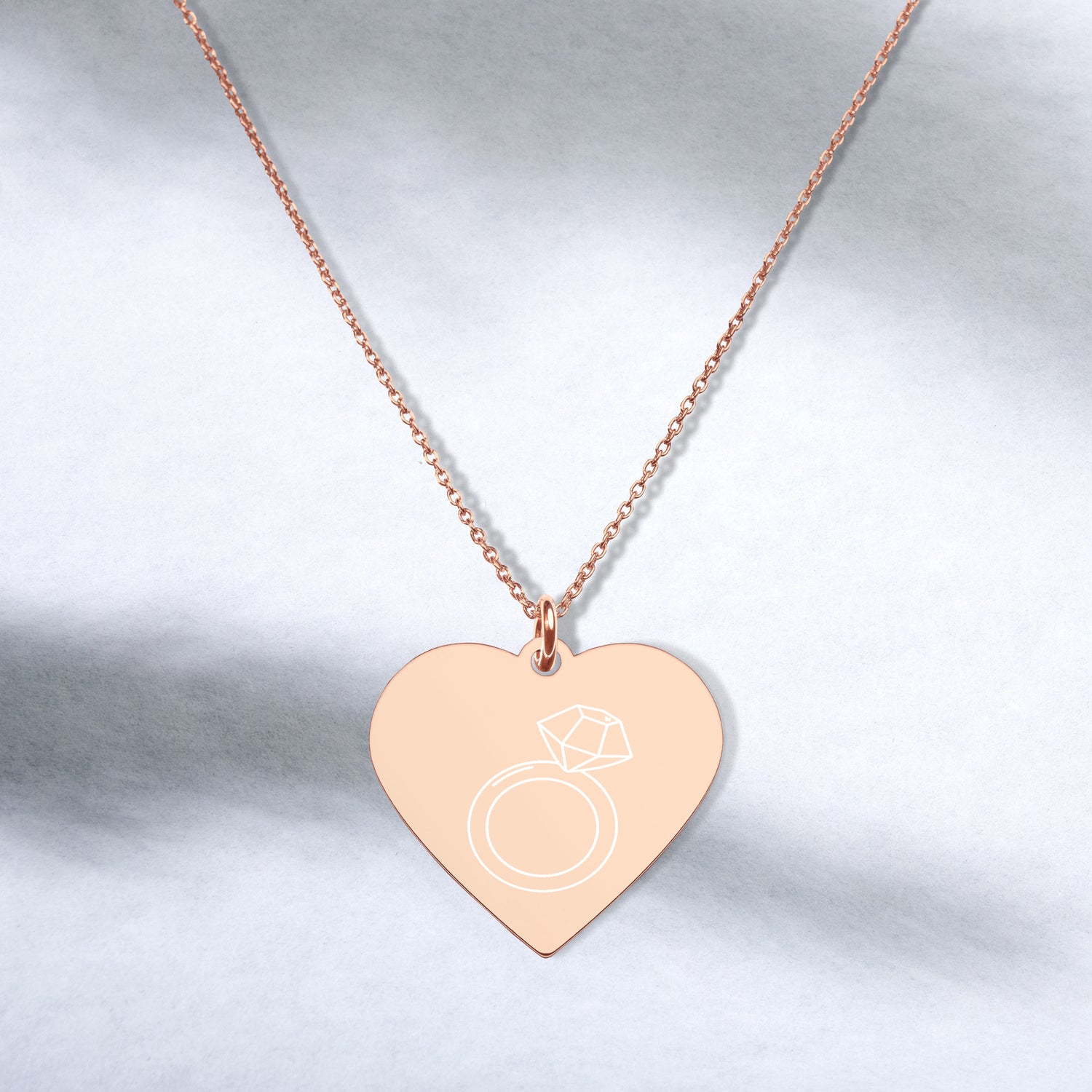 This engraved chain necklace with a sterling silver heart-shaped pendant makes for a perfect accessory for anyone in love with minimalistic and sophisticated jewelryEngraved Silver Heart Necklace