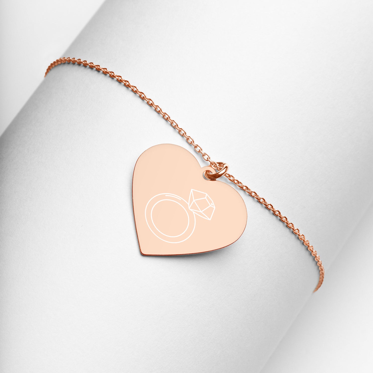 This engraved chain necklace with a sterling silver heart-shaped pendant makes for a perfect accessory for anyone in love with minimalistic and sophisticated jewelryEngraved Silver Heart Necklace