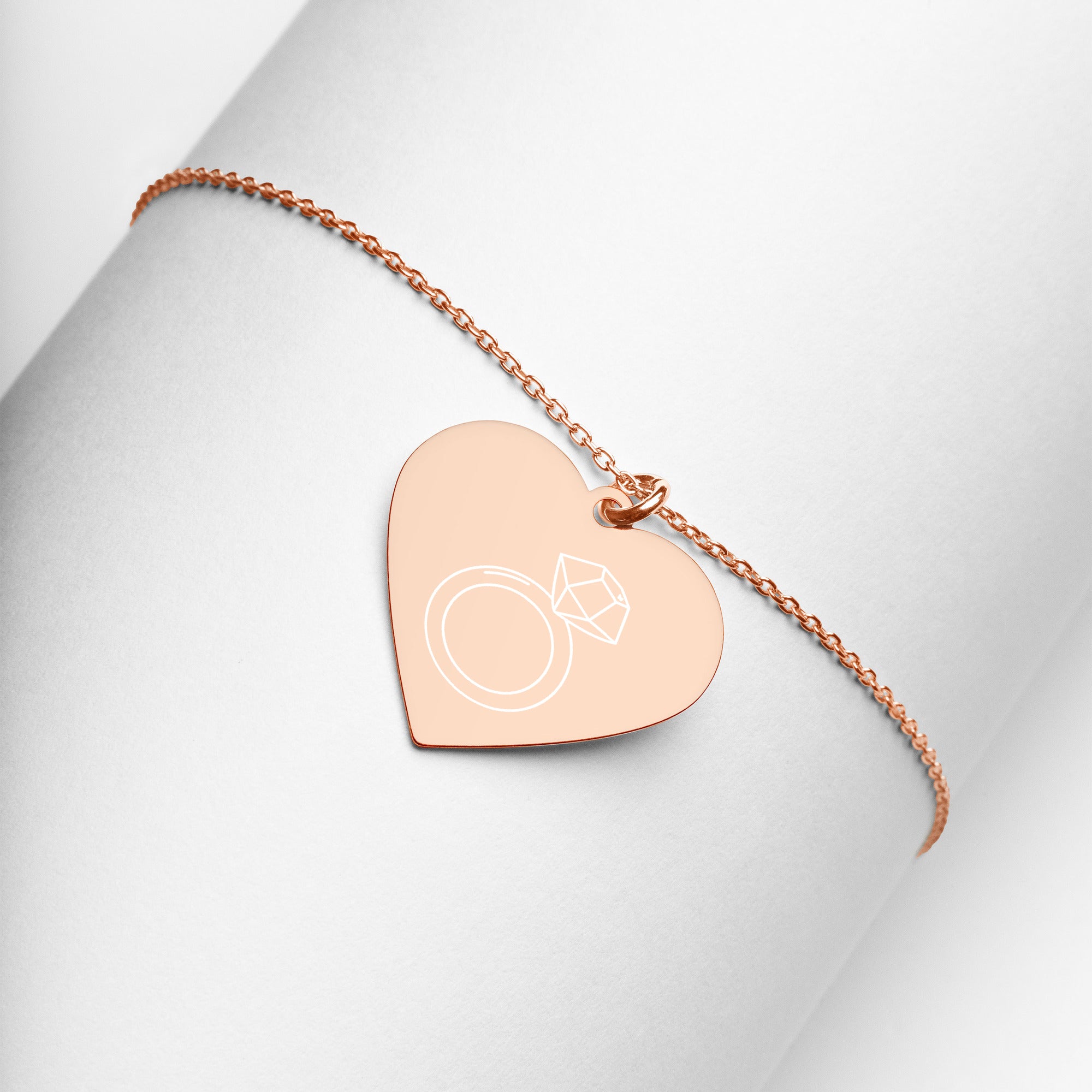 This engraved chain necklace with a sterling silver heart-shaped pendant makes for a perfect accessory for anyone in love with minimalistic and sophisticated jewelryEngraved Silver Heart Necklace